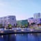 Visionsbild över Lindholmshamnen med dess nya bryggdäck i skymningsljus.